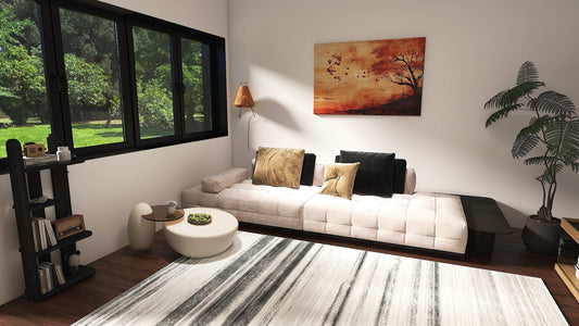 Modern living room featuring a cozy couch, artwork, natural light, and stylish decor elements.